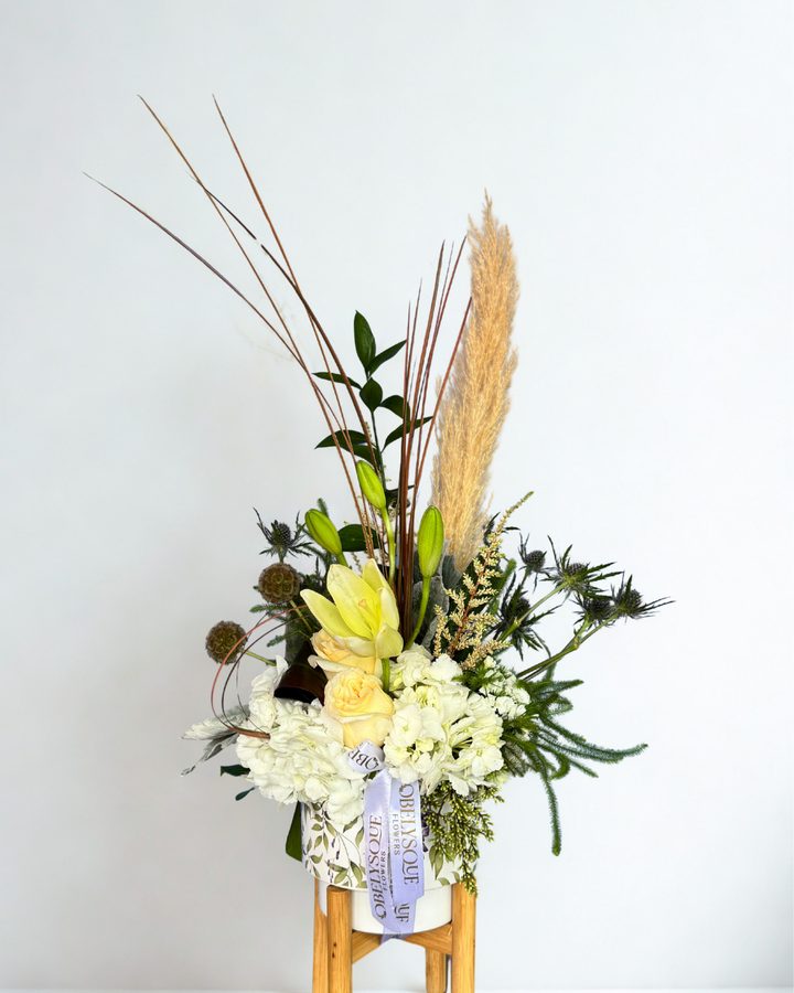 White hydrangea, lilies and pampas in a soft arrangement
